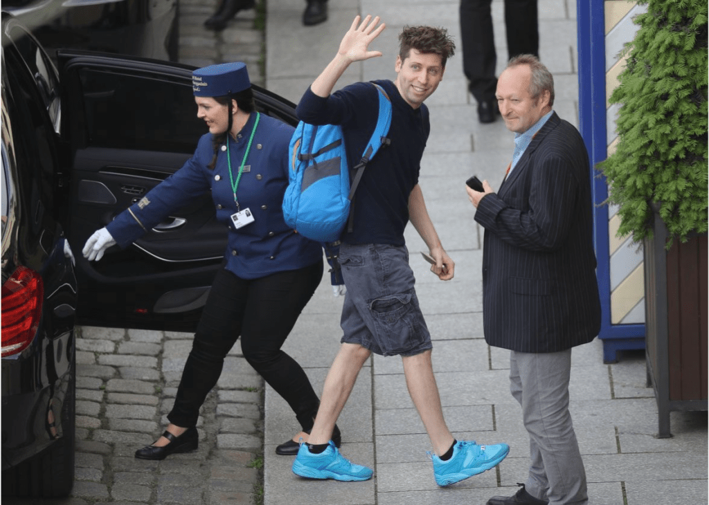 Photo of Sam Altman, CEO of OpenAI, with a blue backpack and matching shoes