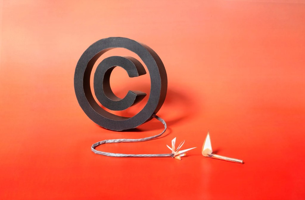 Image of a copyright symbol being lit on fire