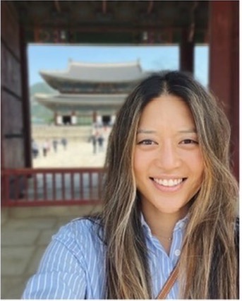Sally Shin is the Co-founder and Chief Operating Officer at Raive in foreground and a temple in the background