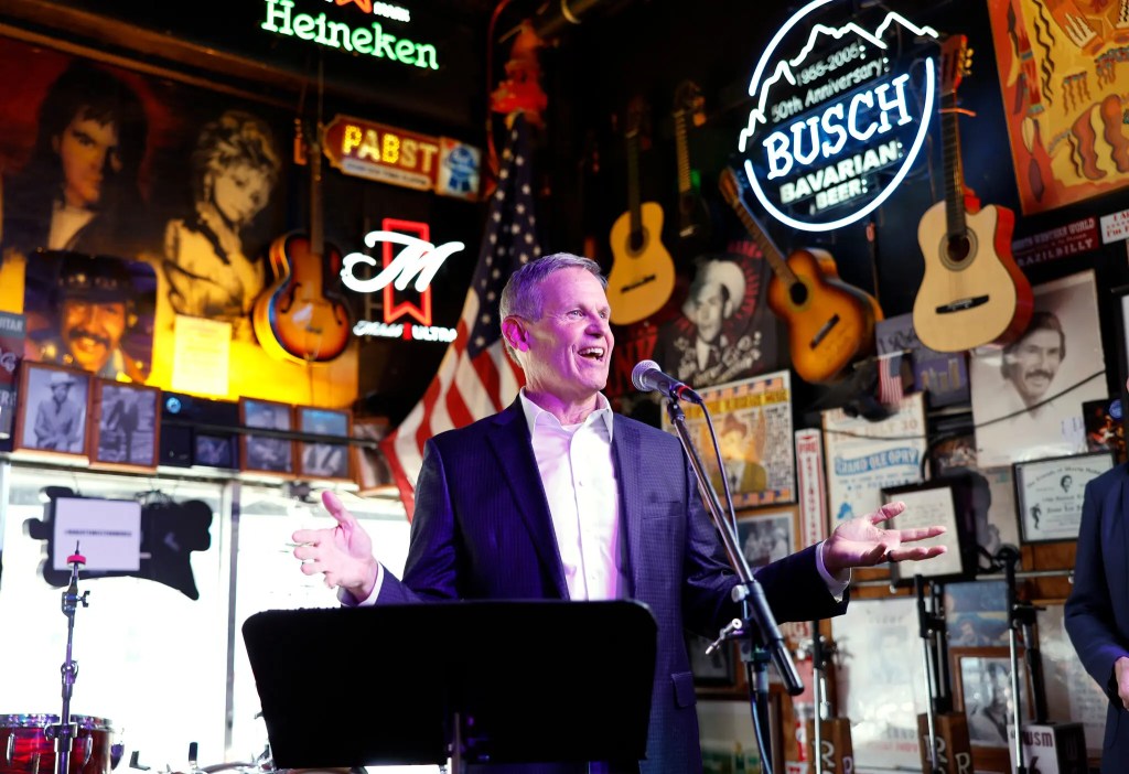 Tennessee governor Bill Lee speaking from a podium at a bar