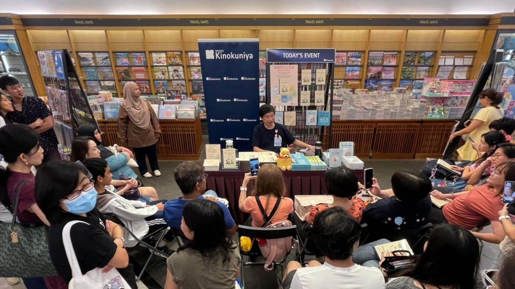 Person in a book store talking to a group of people