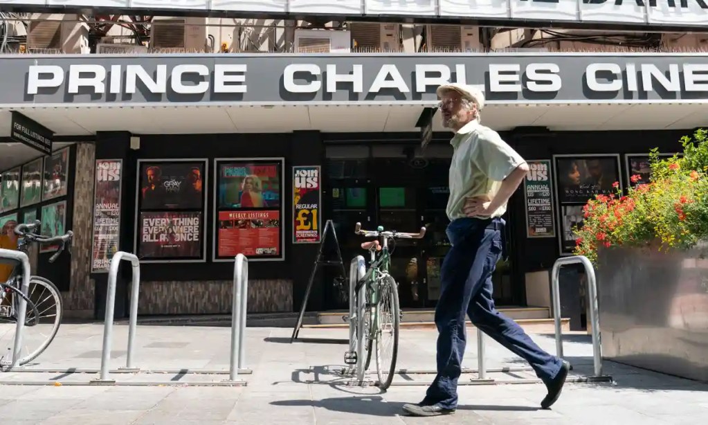 Image of Prince Charles Cinema with man walking in front of it